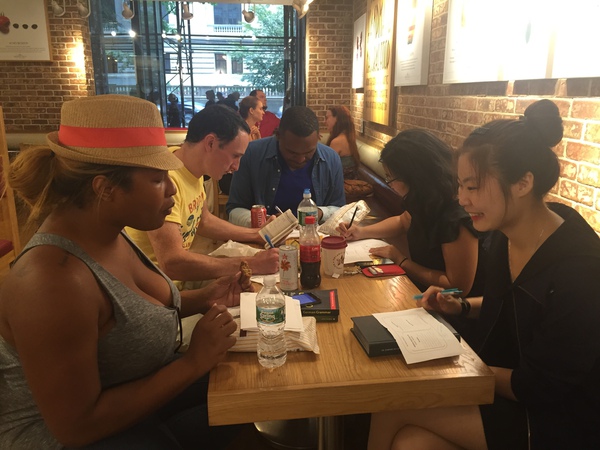Break Diving members gathered around a table for language practice